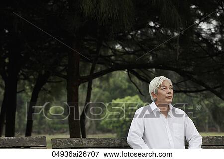 Older man with white hair sitting in park View Large Photo Image Stock Photo - Older man with white hair sitting in park. Fotosearch