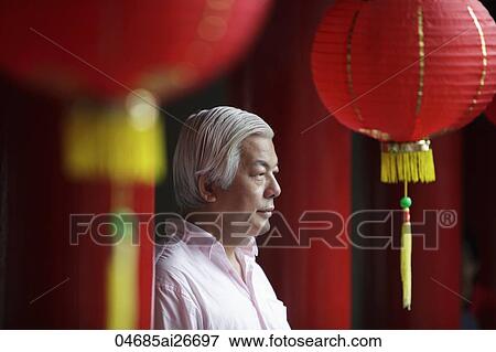 Profile of older man looking at Chinese temple View Large Photo Image Stock Photo - Profile of older man looking at Chinese temple. Fotosearch