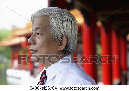 Profile of older man looking out from Chinese temple View Large Photo Image Picture - Profile of older man looking out from Chinese temple. Fotosearch