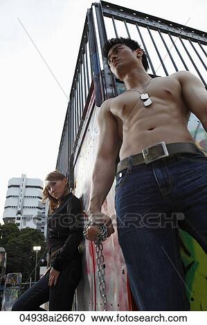 Tough young couple hanging out in the street. View Large Photo Image Stock Image - Tough young couple hanging out in the street.. Fotosearch