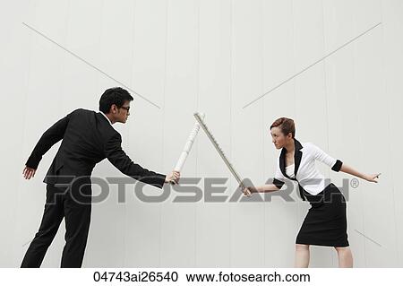 Two people in business suits fighting with rolled up plans View Large Photo Image Stock Image - Two people in business suits fighting with rolled up plans. Fotosearch