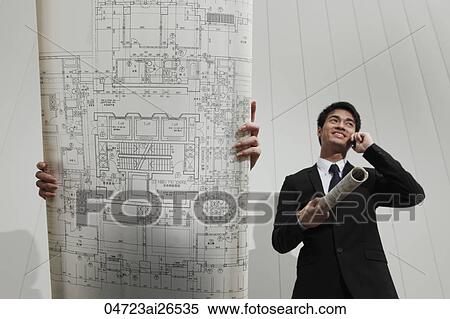 Woman holding plans up in front of her face while Chinese man talks on phone View Large Photo Image Stock Photography - Woman holding plans up in front of her face while Chinese man talks on phone. Fotosearch