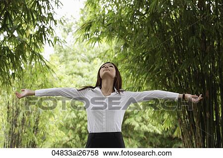 Young woman enjoying nature surrounded by bamboo trees View Large Photo Image Stock Photo - Young woman enjoying nature surrounded by bamboo trees. Fotosearch