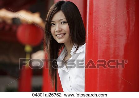 Young woman smiling at camera in front of Chinese temple View Large Photo Image Stock Image - Young woman smiling at camera in front of Chinese temple. Fotosearch