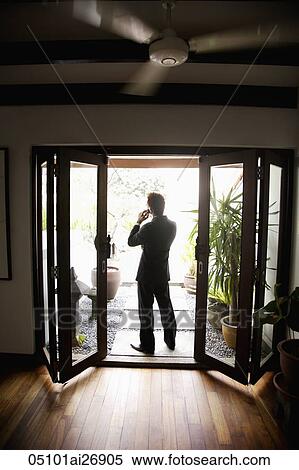 back lit shot of man in suit talking on phone on patio View Large Photo Image Stock Photography - back lit shot of man in suit talking on phone on patio. Fotosearch