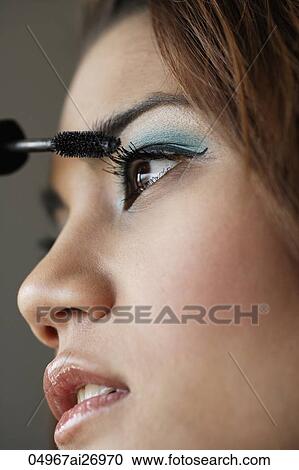 close up of young woman putting on mascara View Large Photo Image Stock Image - close up of young woman putting on mascara. Fotosearch