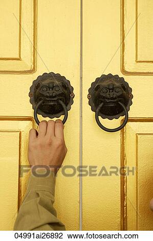 hand reaching up to lion door knockers View Large Photo Image Stock Image - hand reaching up to lion door knockers. Fotosearch