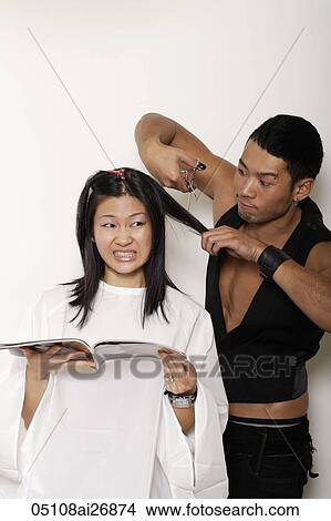 man cutting worried woman's hair View Large Photo Image Picture - man cutting worried woman's hair. Fotosearch
