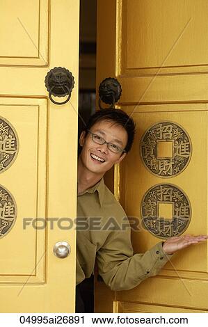 man peeking out from yellow doors. View Large Photo Image Stock Image - man peeking out from yellow doors.. Fotosearch