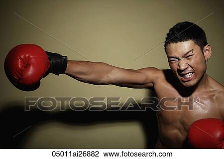 man punching the air with red boxing glove View Large Photo Image Stock Image - man punching the air with red boxing glove. Fotosearch
