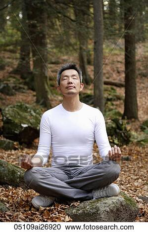 man sitting and meditating in forest View Large Photo Image Stock Image - man sitting and meditating in forest. Fotosearch