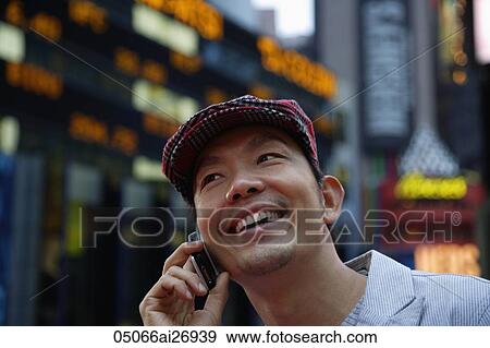 man talking on phone in the evening with city lights as background View Large Photo Image Stock Photo - man talking on phone in the evening with city lights as background. Fotosearch