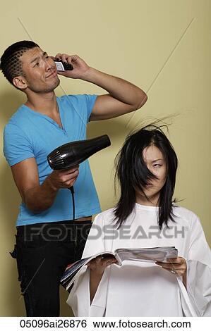 man talking on phone while he blows dried woman's hair. View Large Photo Image Stock Photograph - man talking on phone while he blows dried woman's hair.. Fotosearch