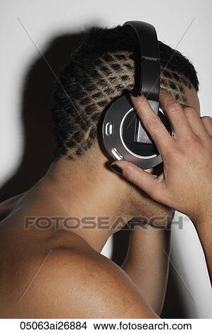 profile shot of man with shaved patterned hair wearing head phones View Large Photo Image Picture - profile shot of man with shaved patterned hair wearing head phones. Fotosearch