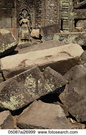 ruins of Angkor Wat with stone carving in background View Large Photo Image Stock Photo - ruins of Angkor Wat with stone carving in background. Fotosearch