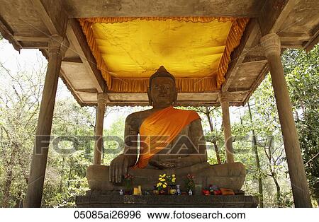 Stone statue of Buddha wearing orange sash. Angkor Wat View Large Photo Image Stock Photograph - Stone statue of Buddha wearing orange sash. Angkor Wat. Fotosearch