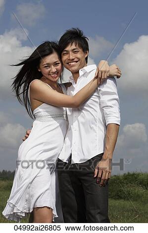 Young couple hugging each other and smiling outside View Large Photo Image Stock Photography - Young couple hugging each other and smiling outside. Fotosearch