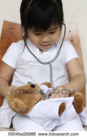 young girl playing doctor with baby bear View Large Photo Image Stock Photograph - young girl playing doctor with baby bear. Fotosearch