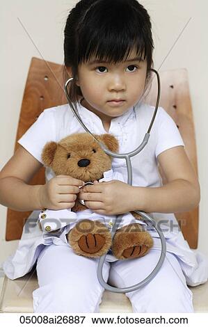 young girl playing doctor with bear View Large Photo Image Stock Photo - young girl playing doctor with bear. Fotosearch