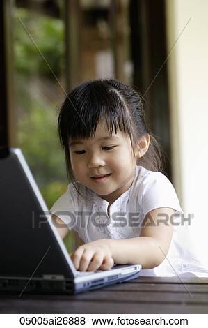 young girl playing with laptop View Large Photo Image Stock Photo - young girl playing with laptop. Fotosearch