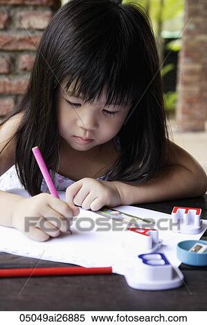 Stock Photography - young girl writing on paper. Fotosearch