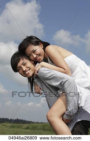 young man carrying a woman on his back outside View Large Photo Image Stock Photo - young man carrying a woman on his back outside. Fotosearch
