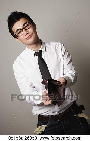 young man wearing glasses holding open empty wallet View Large Photo Image Stock Photo - young man wearing glasses holding open empty wallet. Fotosearch