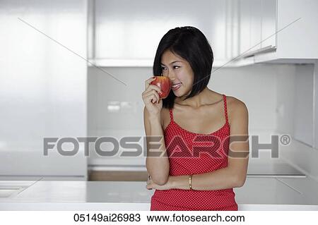 young woman smelling red apple View Large Photo Image Stock Image - young woman smelling red apple. Fotosearch