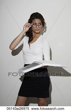 young woman wearing glasses and holding book View Large Photo Image Stock Photography - young woman wearing glasses and holding book. Fotosearch