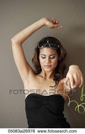 young woman wearing head phones and dancing to music View Large Photo Image Stock Photo - young woman wearing head phones and dancing to music. Fotosearch