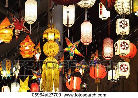 Assortment of different lanterns glowing at night View Large Photo Image Stock Image - Assortment of different lanterns glowing at night. Fotosearch
