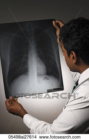 Back shot of doctor holding X ray. View Large Photo Image Picture - Back shot of doctor holding X ray.. Fotosearch