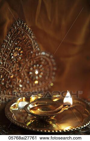 Stock Image - Bronze oil lamp with flame. Fotosearch