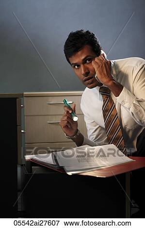 Business man looking at documents with a flashlight at night View Large Photo Image Stock Photo - Business man looking at documents with a flashlight at night. Fotosearch