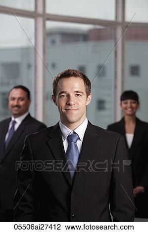 Caucasian man standing in front of his colleagues View Large Photo Image Stock Image - Caucasian man standing in front of his colleagues. Fotosearch