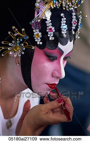 Stock Photo - China, Hong Kong, Portrait of Chinese Opera Actress Applying Make-up. Fotosearch