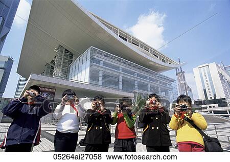 Stock Photo - China, Shanghai, Children Taking Photoes in front of Shanghai Grand Theatre in People's Square. Fotosearch