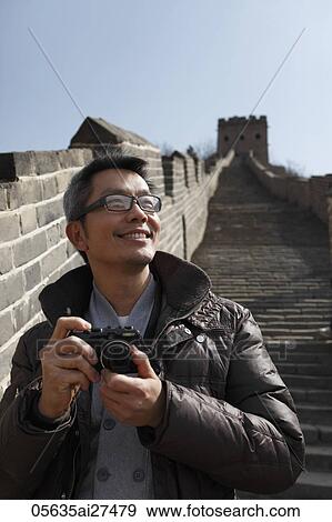 Chinese man holding camera on The Great Wall in China View Large Photo Image Stock Photo - Chinese man holding camera on The Great Wall in China. Fotosearch