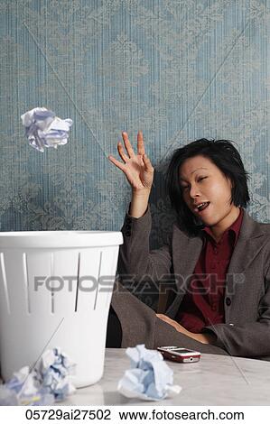 Chinese woman throwing paper in a waste basket View Large Photo Image Stock Image - Chinese woman throwing paper in a waste basket. Fotosearch