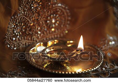 Stock Image - Close up of bronze oil lamp. Fotosearch