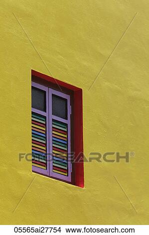 Close up of yellow painted building with bright colored shutters View Large Photo Image Picture - Close up of yellow painted building with bright colored shutters. Fotosearch