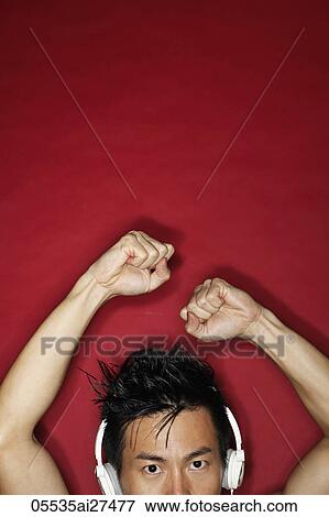 cropped head shot of Chinese man wearing head phones with arms raised. View Large Photo Image Stock Photo - cropped head shot of Chinese man wearing head phones with arms raised.. Fotosearch