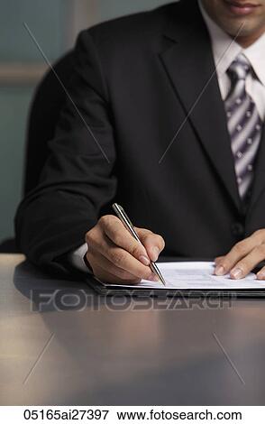 Cropped shot of man writing on document View Large Photo Image Stock Photo - Cropped shot of man writing on document. Fotosearch