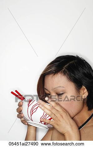 Head shot in profile of young woman eating from soup bowl View Large Photo Image Stock Image - Head shot in profile of young woman eating from soup bowl. Fotosearch