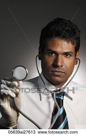 head shot of doctor holding stethoscope View Large Photo Image Stock Image - head shot of doctor holding stethoscope. Fotosearch