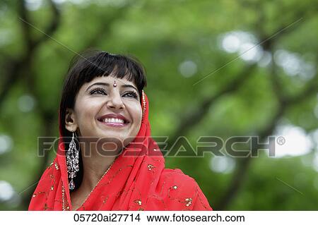 Head shot of Indian woman smiling with red sari over her head View Large Photo Image Picture - Head shot of Indian woman smiling with red sari over her head. Fotosearch