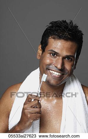 Head shot of man holding toothbrush and smiling View Large Photo Image Stock Image - Head shot of man holding toothbrush and smiling. Fotosearch