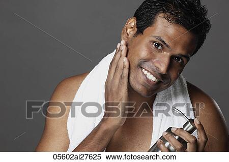 Head shot of man rubbing his skin with lotion View Large Photo Image Stock Photography - Head shot of man rubbing his skin with lotion. Fotosearch