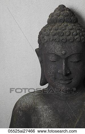 Stock Photograph - Head shot of stone Buddha. Fotosearch