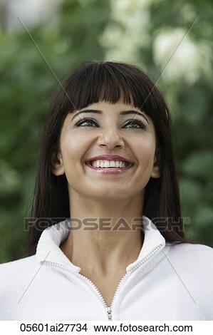 Head shot of woman looking up and smiling View Large Photo Image Picture - Head shot of woman looking up and smiling. Fotosearch